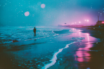 Obraz premium Man walking on the beach at night. Photo in old color image style