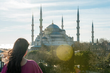 Young woman looking on amazing Blue Mosque in Istanbul, Turkey.