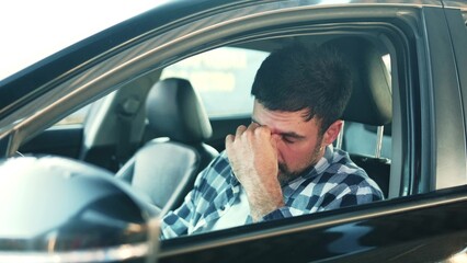 Sadness young man feeling stressed, sitting at driver seat in a car. Transport, people, lifestyle...