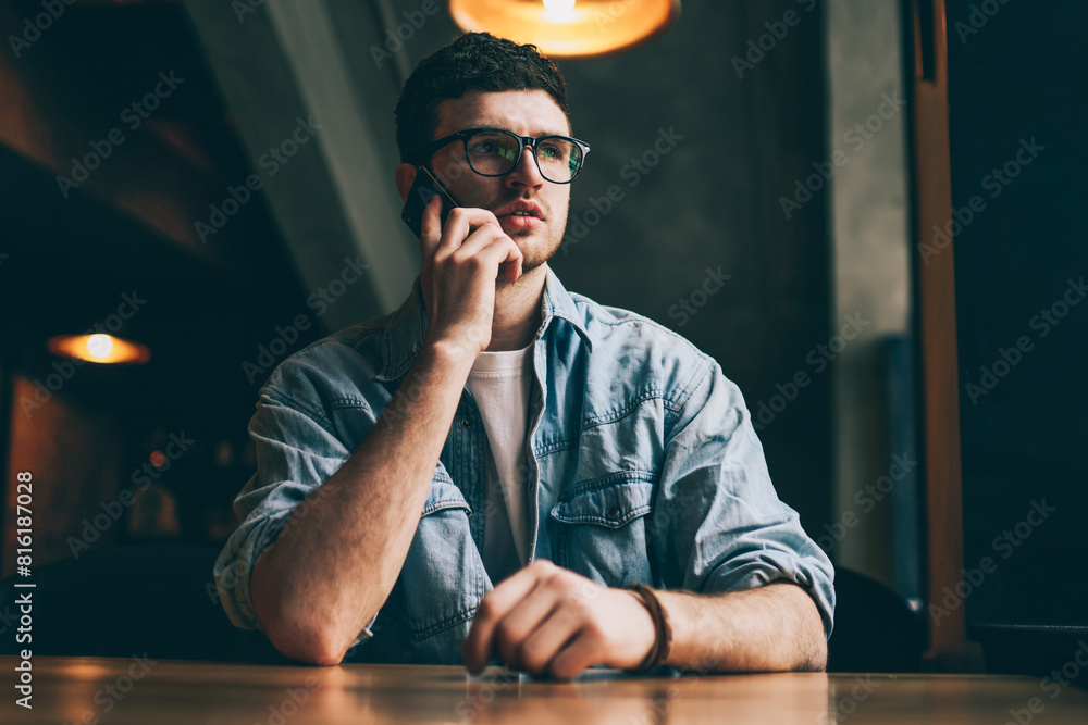 Poster serious concentrated man calling to operator for checking account balance using smartphone with 4g i