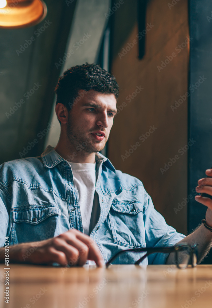 Poster confused hipster guy reading email with bad news from colleague using application for chatting on sm
