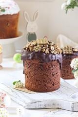 Easter cake with chocolate icing and luxurious gold walnut topping, presented in a festive setting.