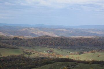 autumn landscape in the mountains With farm in the valley