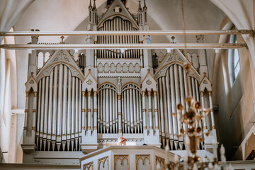 Valmiera, Latvia - May 12, 2024 - a large church organ with ornate pipes and gothic architectural...