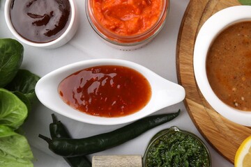 Different marinades on white table, flat lay