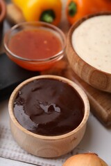 Fresh marinade in bowl on white wooden table, closeup