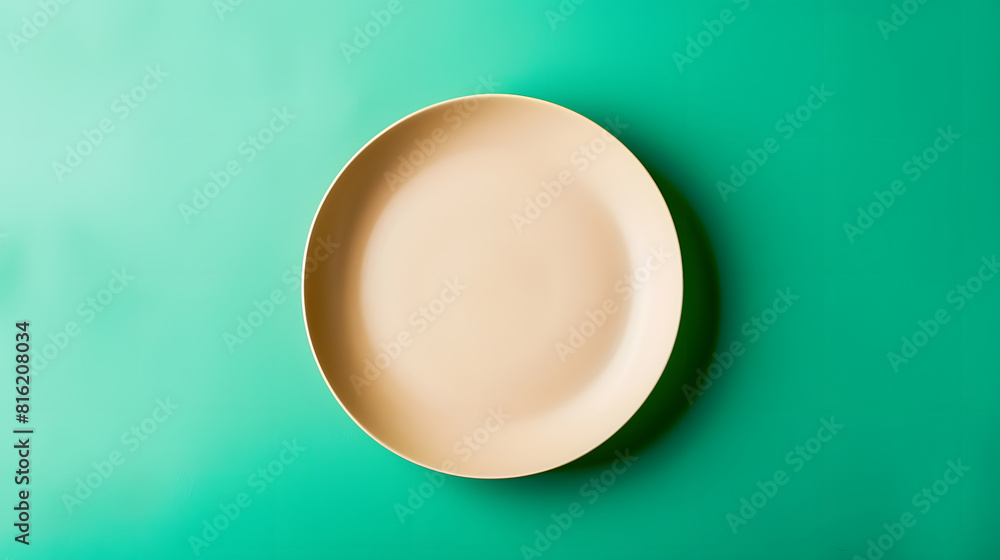 Aufkleber empty beige plate on green pastel paper background top view flat lay textured object selective focus