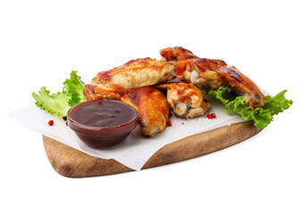 Board with marinade, chicken wings, spices and lettuce isolated on white
