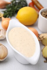 Fresh marinade and different ingredients on light grey table, closeup