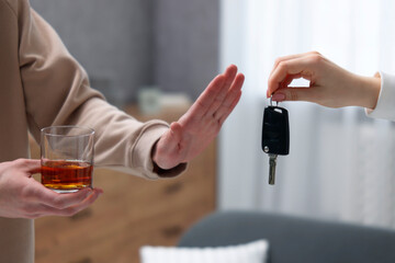 Drunk man refusing drive car while woman suggesting him keys, closeup. Don't drink and drive concept