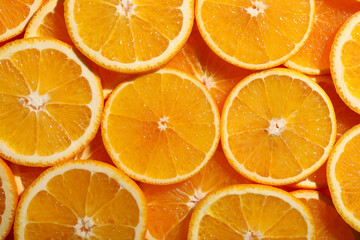 Slices of juicy orange as background, top view