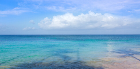 Fototapeta premium Tropical paradise beach with white sand and blue sky.