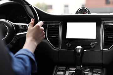 Woman using navigation system while driving her car, closeup