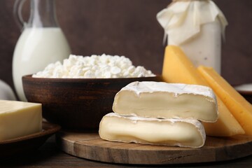 Different fresh dairy products on wooden table, closeup