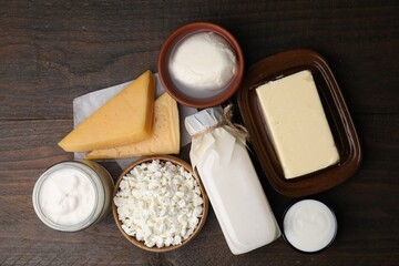 Different fresh dairy products on wooden table, top view
