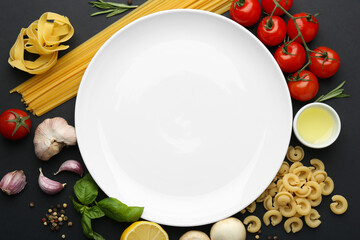 Plate surrounded by different types of pasta, products and peppercorns on black background, flat...
