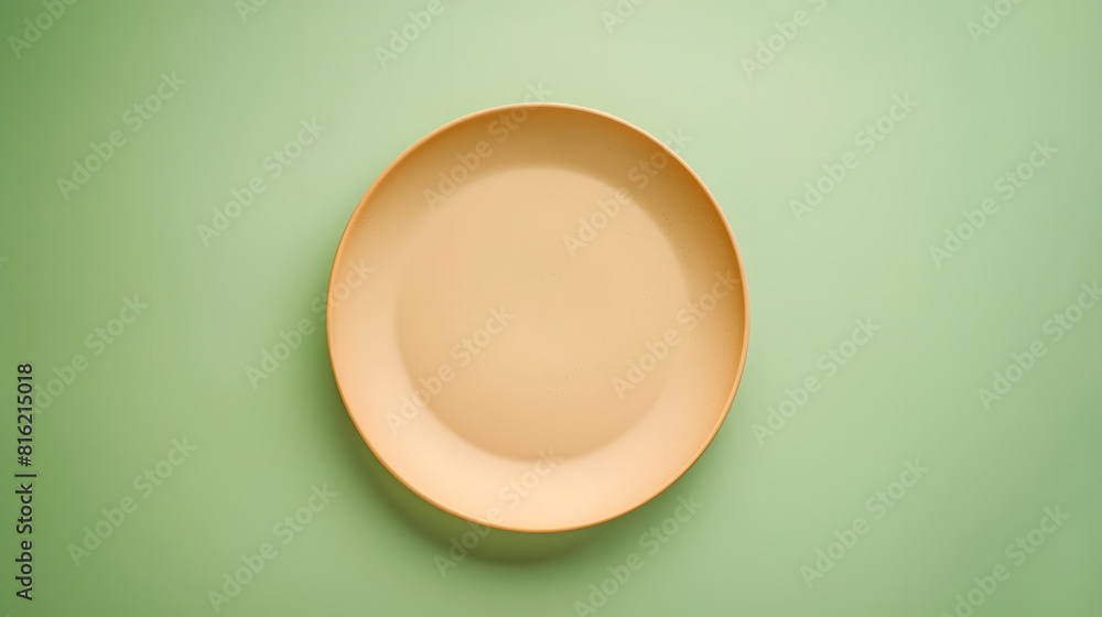 Poster empty beige plate on green pastel paper background top view flat lay textured object selective focus