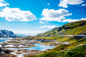 Majestic mountains with grass and blue sky in Norway