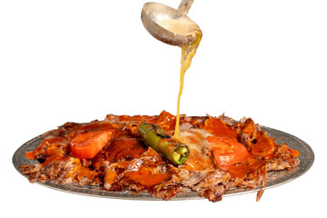 iskender kebab. Traditional Turkish cuisine flavor with tomato sauce and butter. iskender kebab...