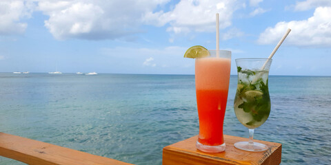 Travel background with drinks Bocal on Caribbean beach.