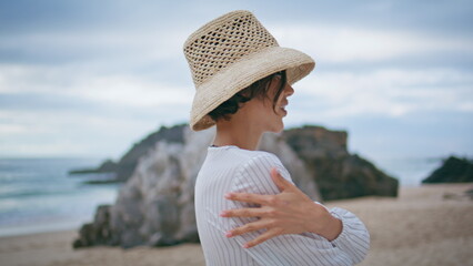 Smiling model enjoying coast vacation closeup. Happy beach woman spreading arms
