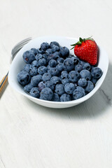 White bowl with fresh blueberries seen from above