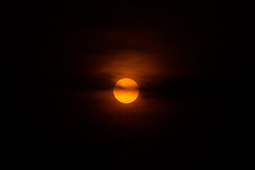 Night sky eclipse above water and land