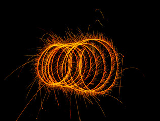 Orange swirl with letter "o" inside, against black backdrop