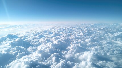 Fototapeta premium Expansive Mammatus Clouds Seen from Airplane Window with Clear Blue Sky and Sunlit Cloud Formations
