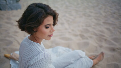 Calm girl enjoying seashore picnic closeup. Pretty woman drinking orange juice