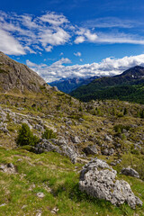 Alpine scenes of the Dolomite mountains Italy. With lush green pastures and snow topped mountain vistas. Mountain lake Laghi dei Piani near Tre Cime in Dolomites. Panorama of beautiful mountains.