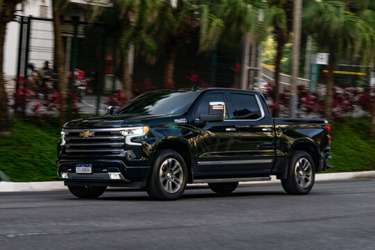 Panning shot of a black Chevrolet Silverado - copy space - black full size pickup truck