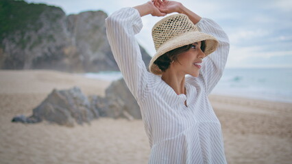 Beautiful girl enjoy breeze on summer beach. Smiling dreamy woman closing eyes