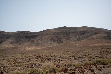 Arid, volcanic landscape of the southern side of Jandia Nature Reserve, Jandia Peninsula, Fuerteventura, Spain