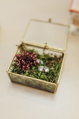 Wedding rings in a beautiful handmade glass box with flowers