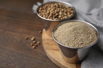 Ground pepper and peppercorns on wooden table, closeup. Space for text