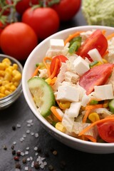 Tasty salad with Chinese cabbage served on black table, closeup