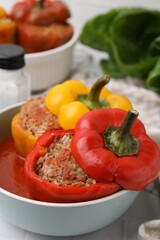 Delicious stuffed bell peppers on white table, closeup