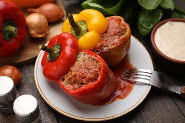 Delicious stuffed bell peppers served on wooden table