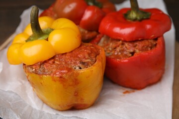 Delicious stuffed bell peppers served on table, closeup