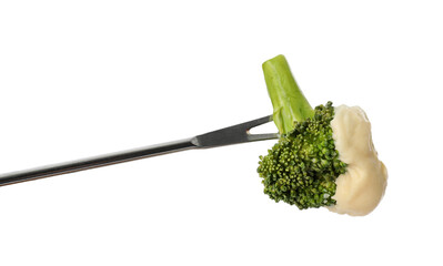 Tasty fondue. Fork with broccoli and melted cheese isolated on white