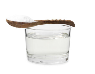 Vinegar in glass bowl, baking soda and spoon isolated on white
