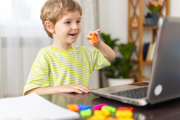 Young Boy Engaged in Online Learning with Educational Toys