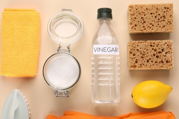 Eco friendly natural cleaners. Flat lay composition with bottle of vinegar on beige background