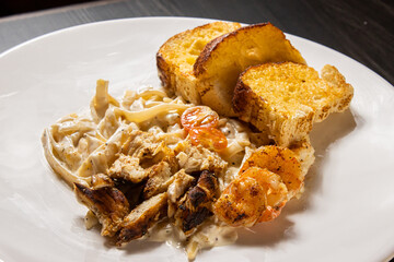  dish of pasta and Shrimp and bread