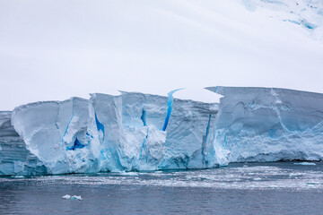 Turquoise and Teal Blue Crevices Iceberg Viewed from a Pontoon Boat Excursion in The Gullet Channel Antarctica 