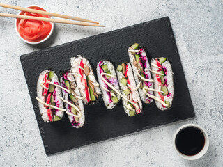 Vegan sushi sandwich onigirazu with mushrooms and vegetables. Healthy dinner recipe and idea. Colorful japan sandwich onigirazu with red cabbage,radish,cucumber,mushrooms. Trend food. Top view