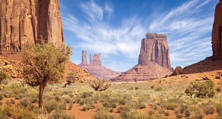 Large red sandstone buttes and spire formations in Monument  Valley from the valley floor, Arizona, USA on 22 April 2024
