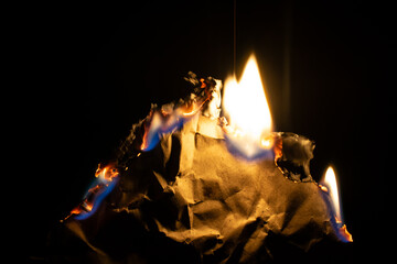 burning paper, glowing edge of paper on a black background.