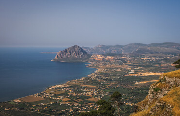Fototapeta premium Scenic panoramic view from Erice town at sea coast with monte Cofano in Sicily, Italy, Europe. June 2023